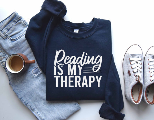 A navy color sweatshirt with the saying "Reading is my therapy"