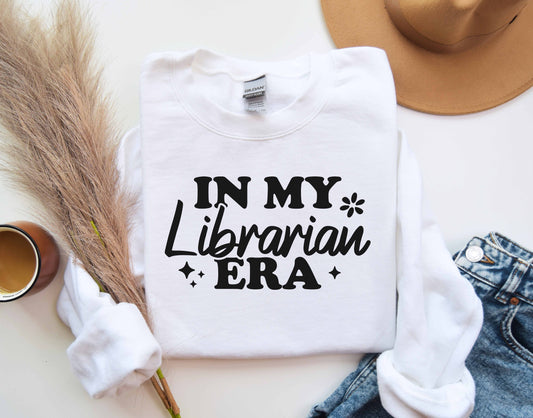 A white color sweatshirt with the saying "In my librarian era"