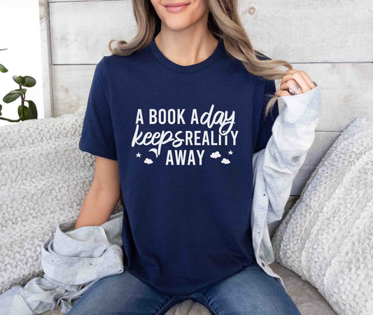 A navy color shirt with the saying "A book a day keeps reality away"