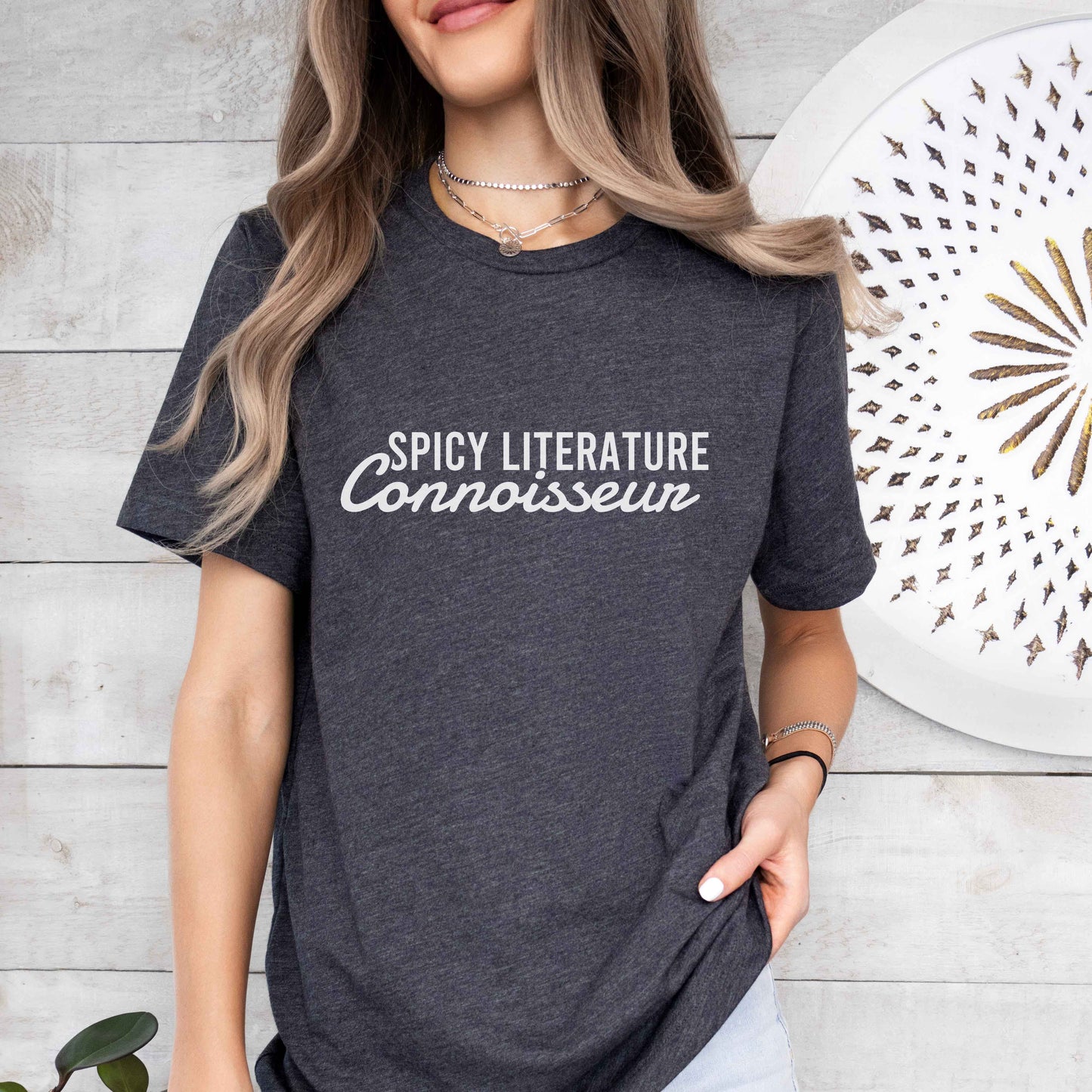 Person wearing a dark gray heather t-shirt with 'Spicy Literature Connoisseur' text.