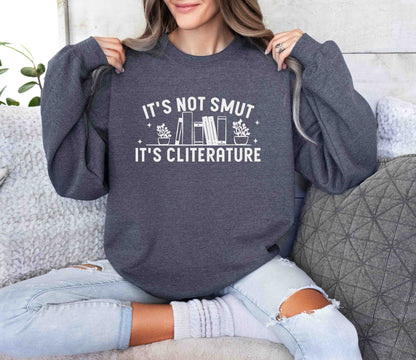 Person wearing a dark heather sweatshirt with text sitting on a couch.