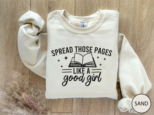 Folded sand color sweatshirt with text and graphic on a wooden surface