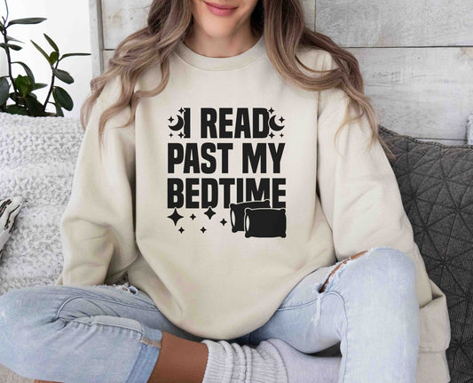 A sand color sweatshirt with the saying "I read past my bedtime"