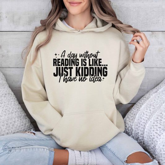 A sand color hoodie with the saying "A day without reading is like just kidding I have no idea"