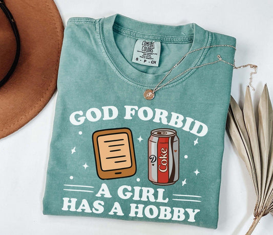 A comfort colors® shirt with the saying "god forbid a girl has a hobby"