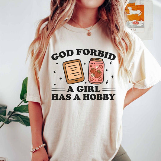 A comfort colors® shirt with the saying "god forbid a girl has a hobby"