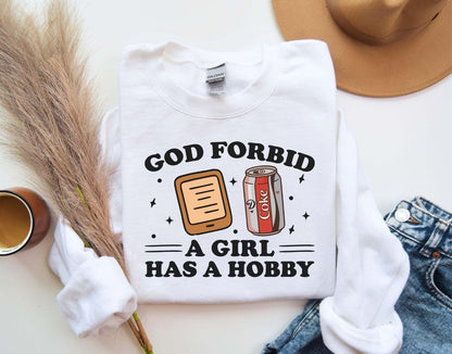 A Gildan 18000 sweatshirt with the saying "god forbid a girl has a hobby"