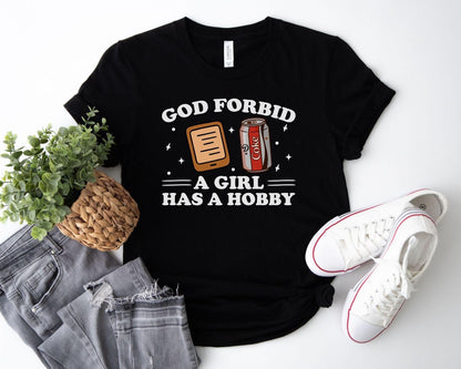 A bella canvas 3001 shirt with the saying "god forbid a girl has a hobby"