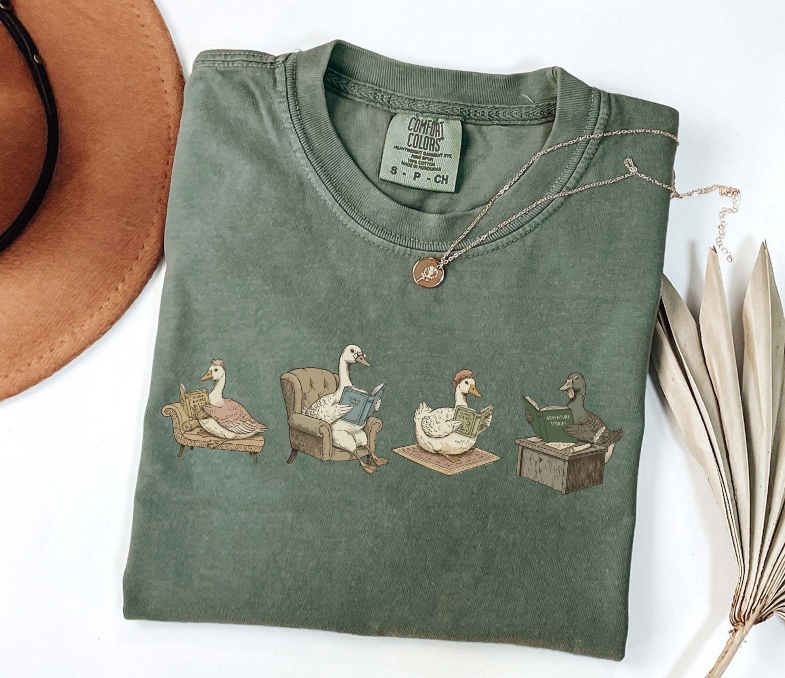 A comfort colors® shirt with the saying "goose reading a book"