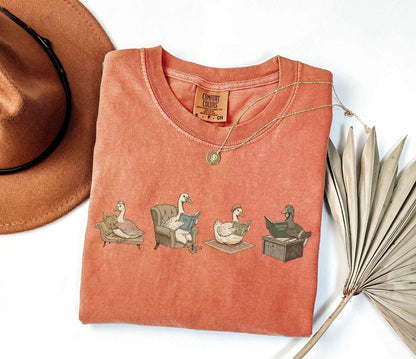 A comfort colors® shirt with the saying "goose reading a book"