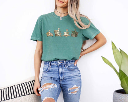 A comfort colors® shirt with the saying "goose reading a book"