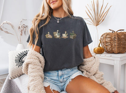 A comfort colors® shirt with the saying "goose reading a book"