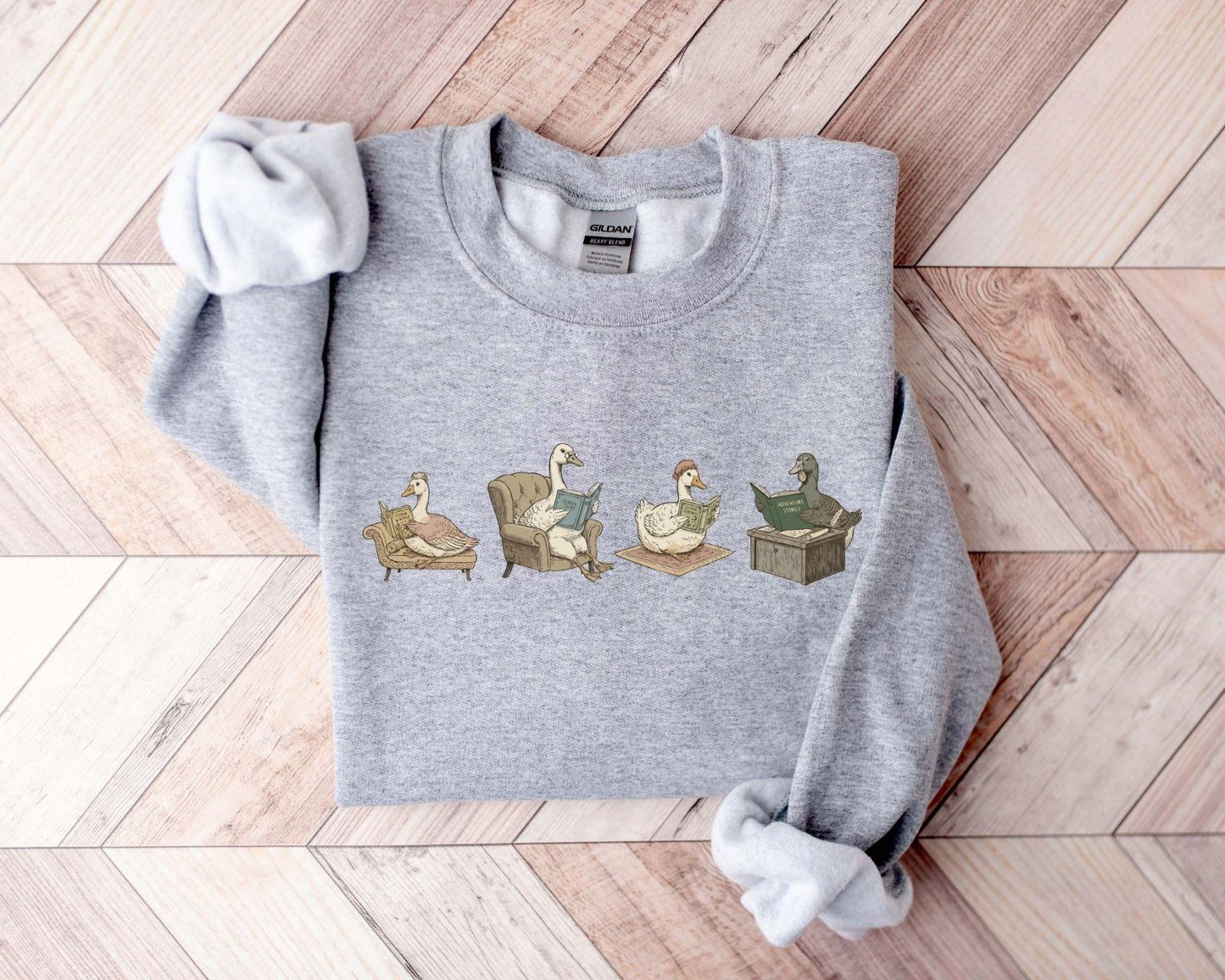 A Gildan 18000 sweatshirt with the saying "goose reading a book"