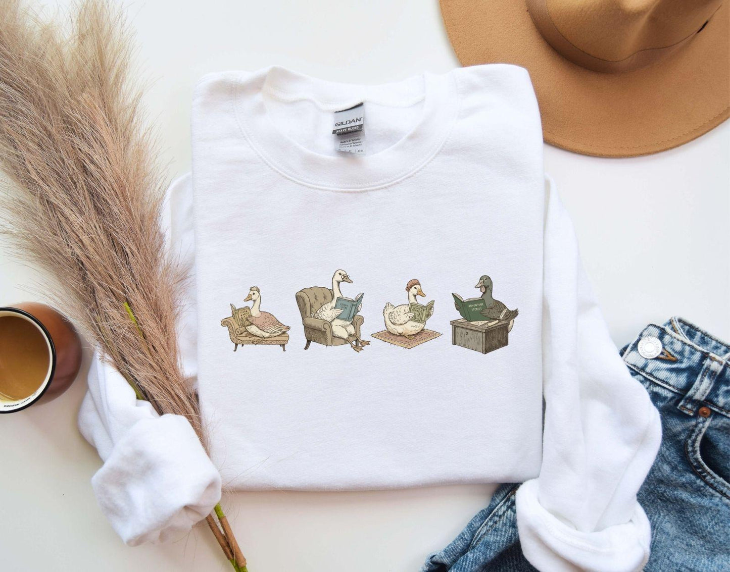 A Gildan 18000 sweatshirt with the saying "goose reading a book"