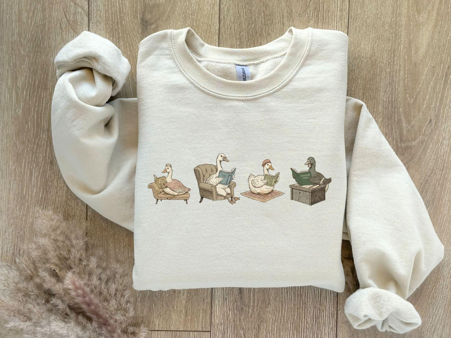 A Gildan 18000 sweatshirt with the saying "goose reading a book"