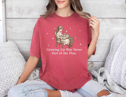 A comfort colors® shirt with the saying "Growing Up Was Never Part of the Plan"