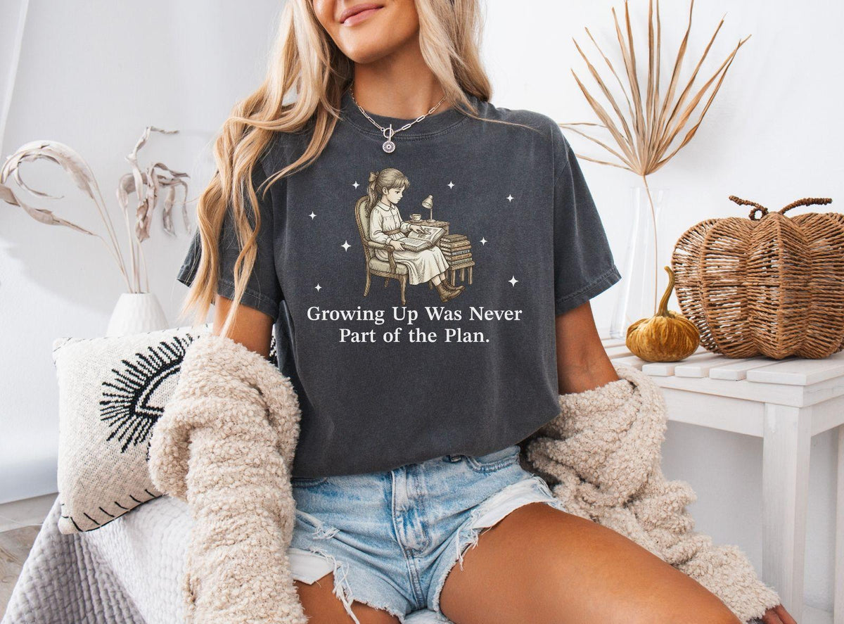 A comfort colors® shirt with the saying "Growing Up Was Never Part of the Plan"