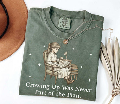 A comfort colors® shirt with the saying "Growing Up Was Never Part of the Plan"