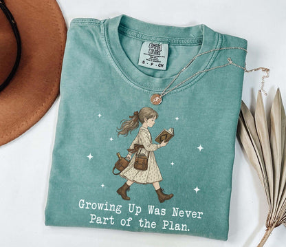 A comfort colors® shirt with the saying "Growing Up Was Never Part of the Plan "
