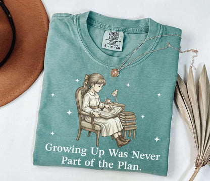 A comfort colors® shirt with the saying "Growing Up Was Never Part of the Plan"