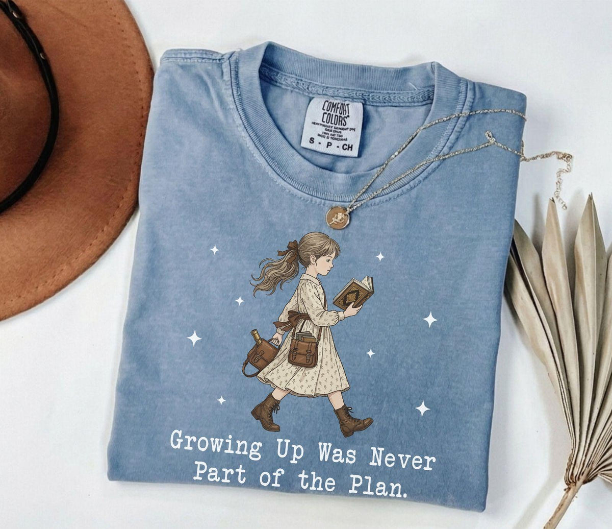 A comfort colors® shirt with the saying "Growing Up Was Never Part of the Plan "