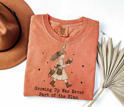 A comfort colors® shirt with the saying "Growing Up Was Never Part of the Plan "