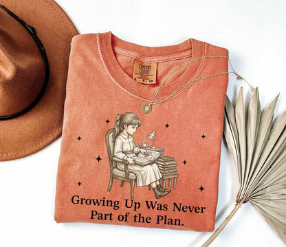 A comfort colors® shirt with the saying "Growing Up Was Never Part of the Plan"