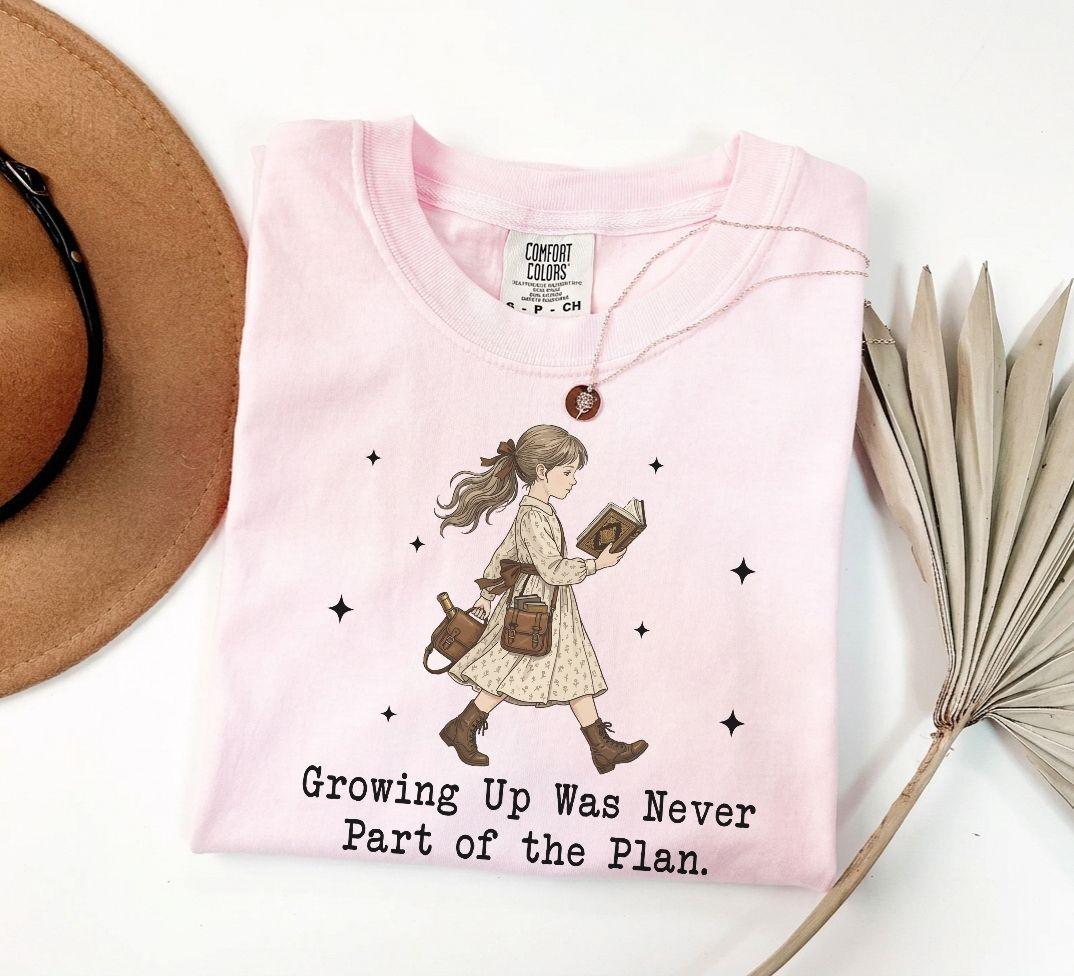 A comfort colors® shirt with the saying "Growing Up Was Never Part of the Plan "