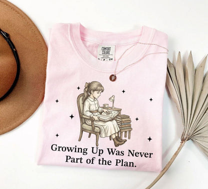 A comfort colors® shirt with the saying "Growing Up Was Never Part of the Plan"