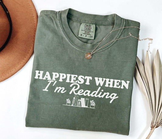 A comfort colors® shirt with the saying "happiest when i'm reading"