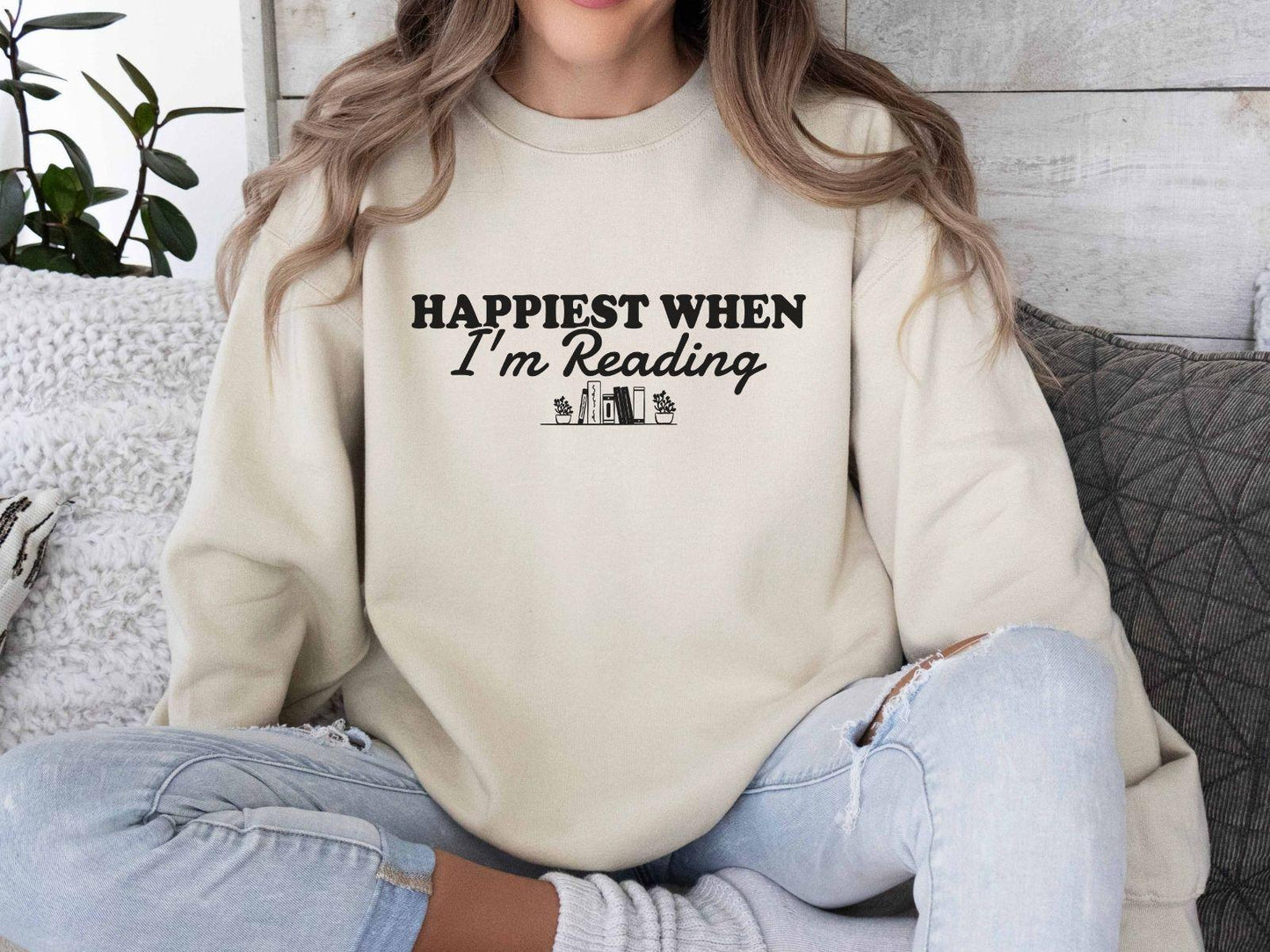 A Gildan 18000 sweatshirt with the saying "Happiest when I'm reading"