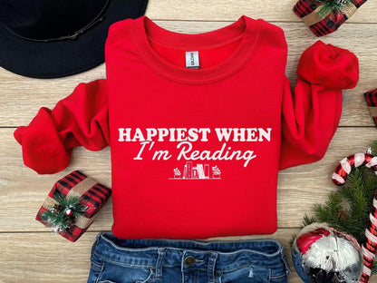 A Gildan 18000 sweatshirt with the saying "Happiest when I'm reading"