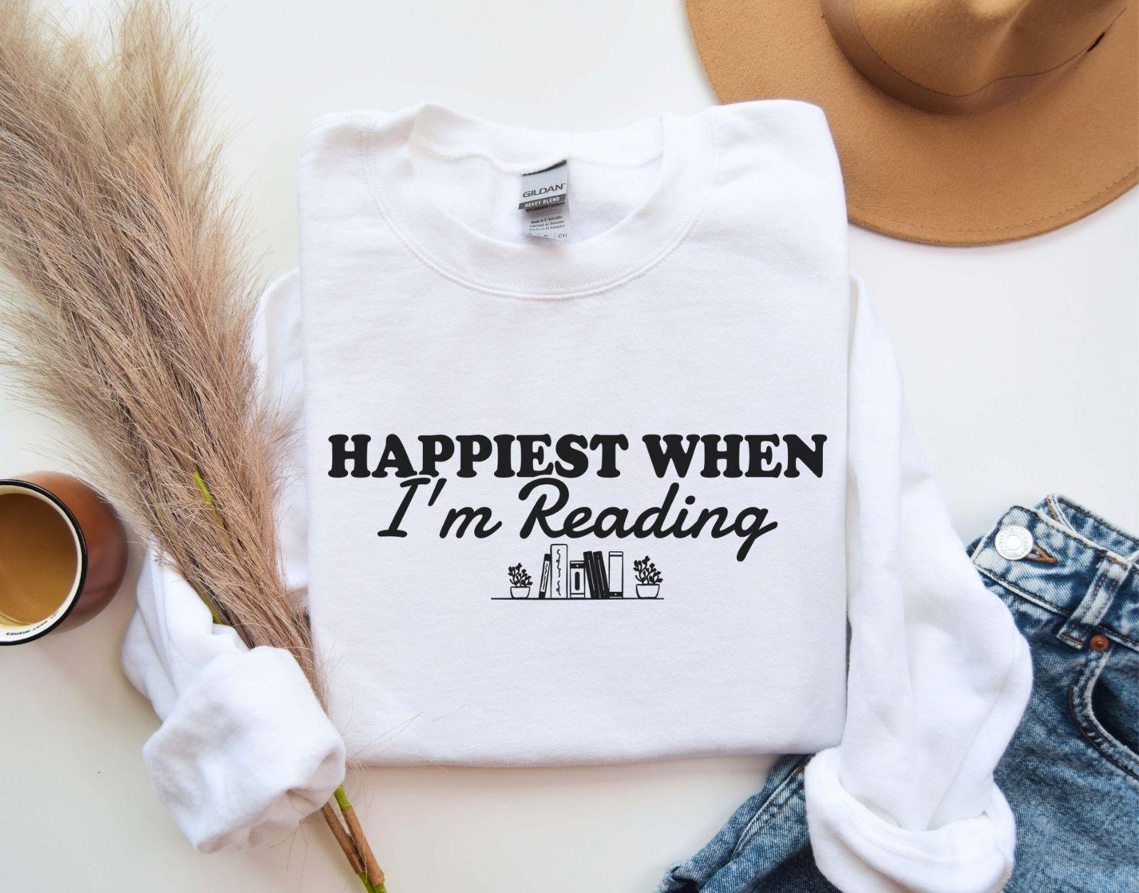 A Gildan 18000 sweatshirt with the saying "Happiest when I'm reading"