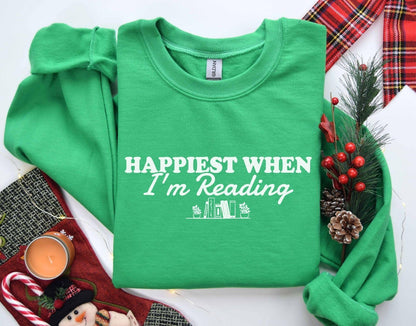 A Gildan 18000 sweatshirt with the saying "Happiest when I'm reading"