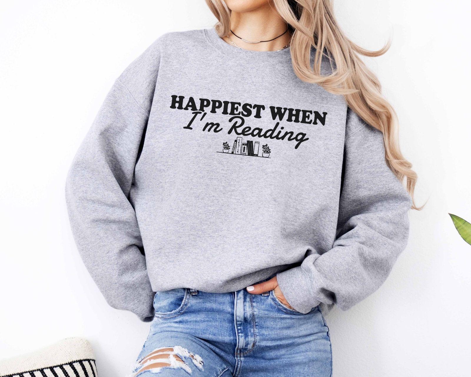 A Gildan 18000 sweatshirt with the saying "Happiest when I'm reading"