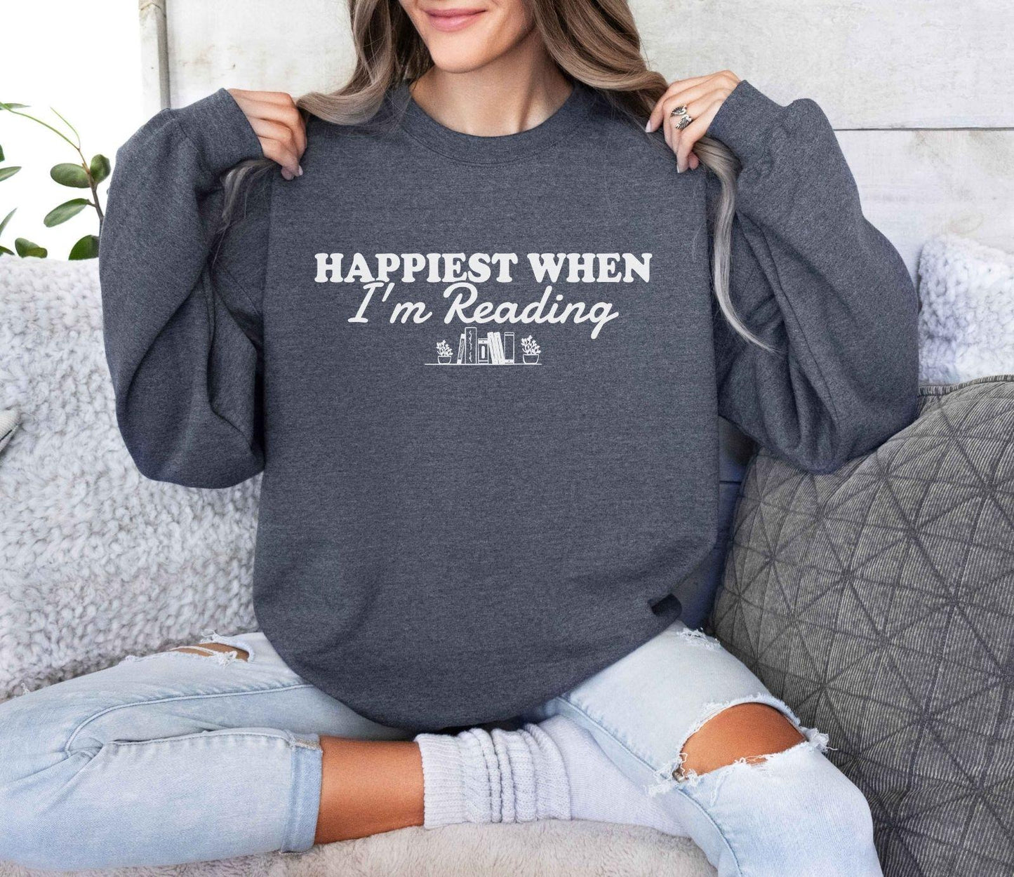 A Gildan 18000 sweatshirt with the saying "Happiest when I'm reading"