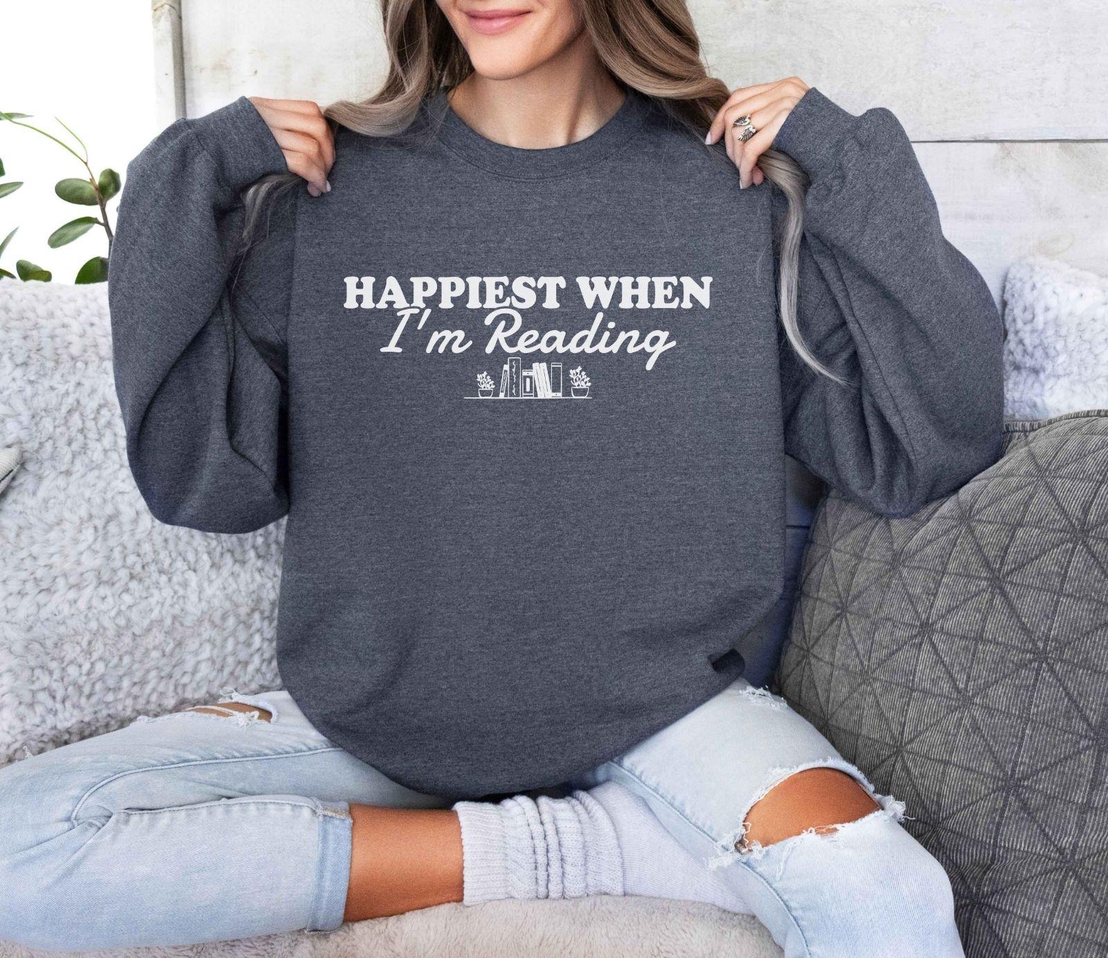 A Gildan 18000 sweatshirt with the saying "Happiest when I'm reading"