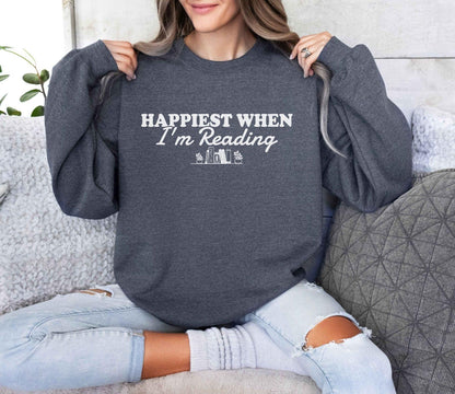 A Gildan 18000 sweatshirt with the saying "Happiest when I'm reading"