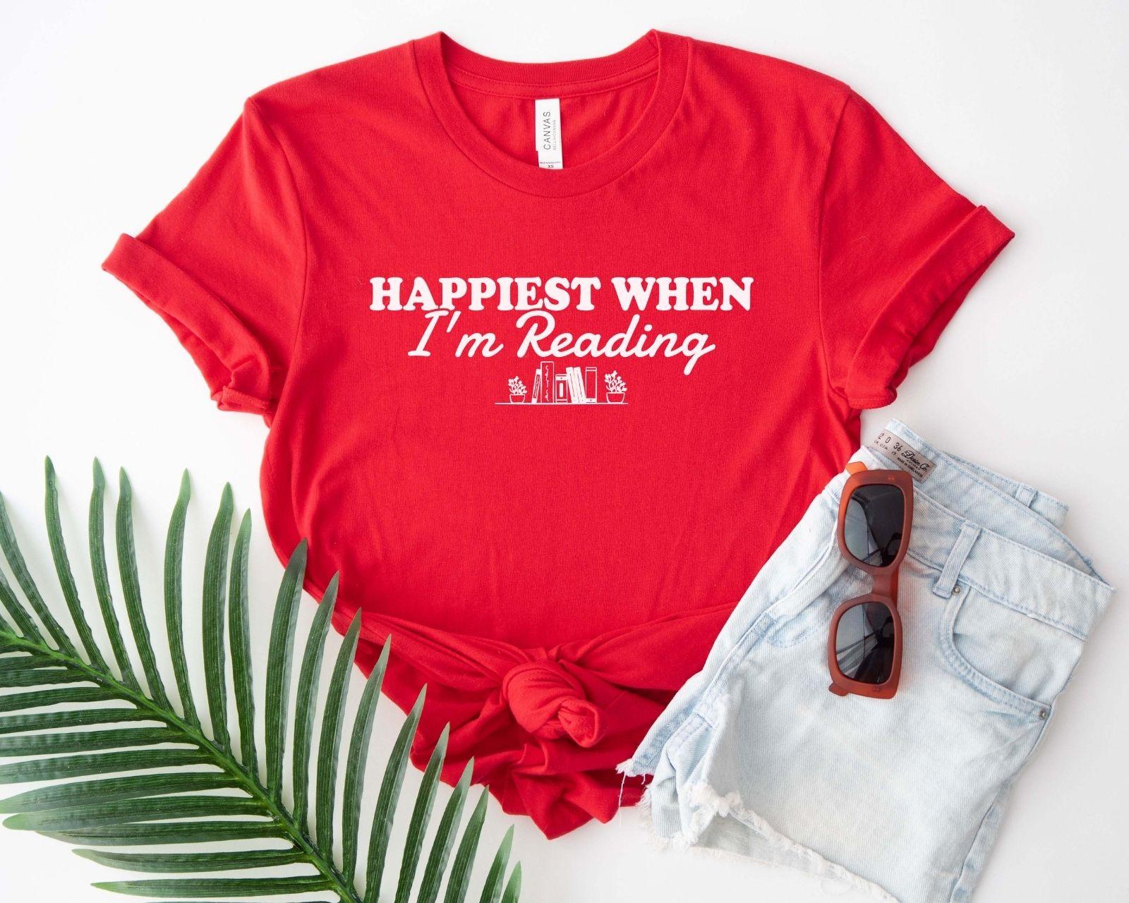 A bella canvas 3001 shirt with the saying "happiest when i'm reading"