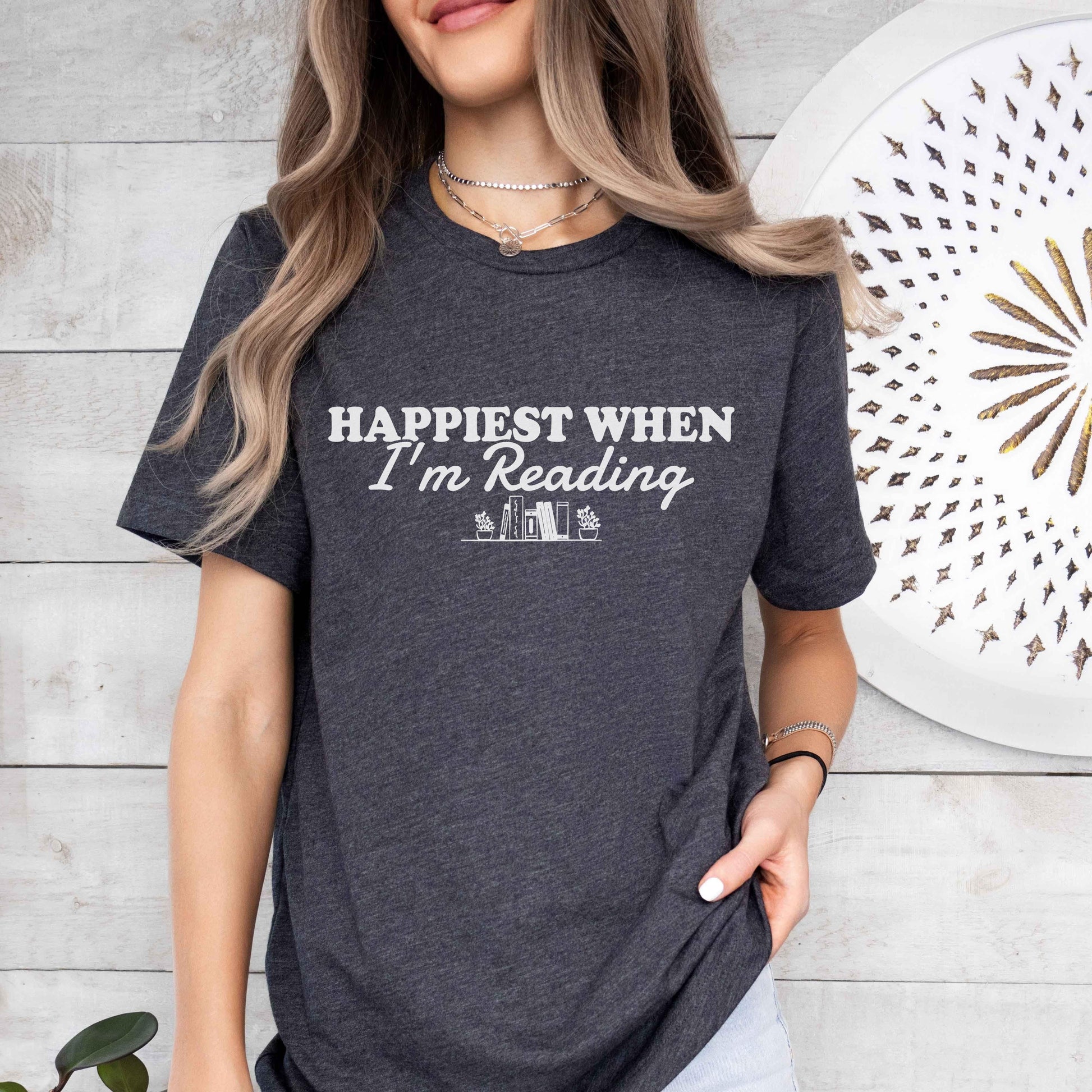 A bella canvas 3001 shirt with the saying "happiest when i'm reading"