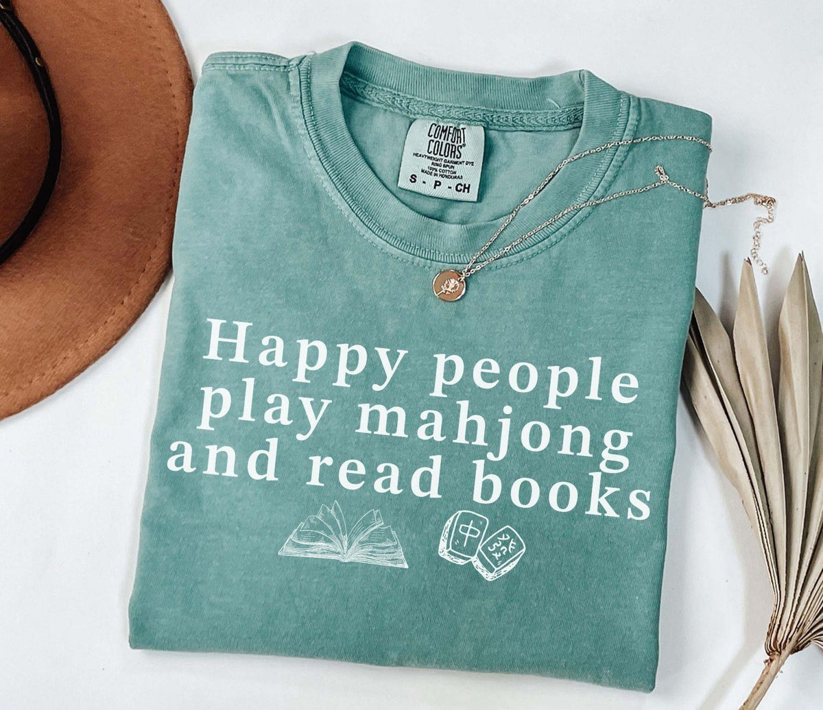 A comfort colors® shirt with the saying "Happy people play mahjong and read books"