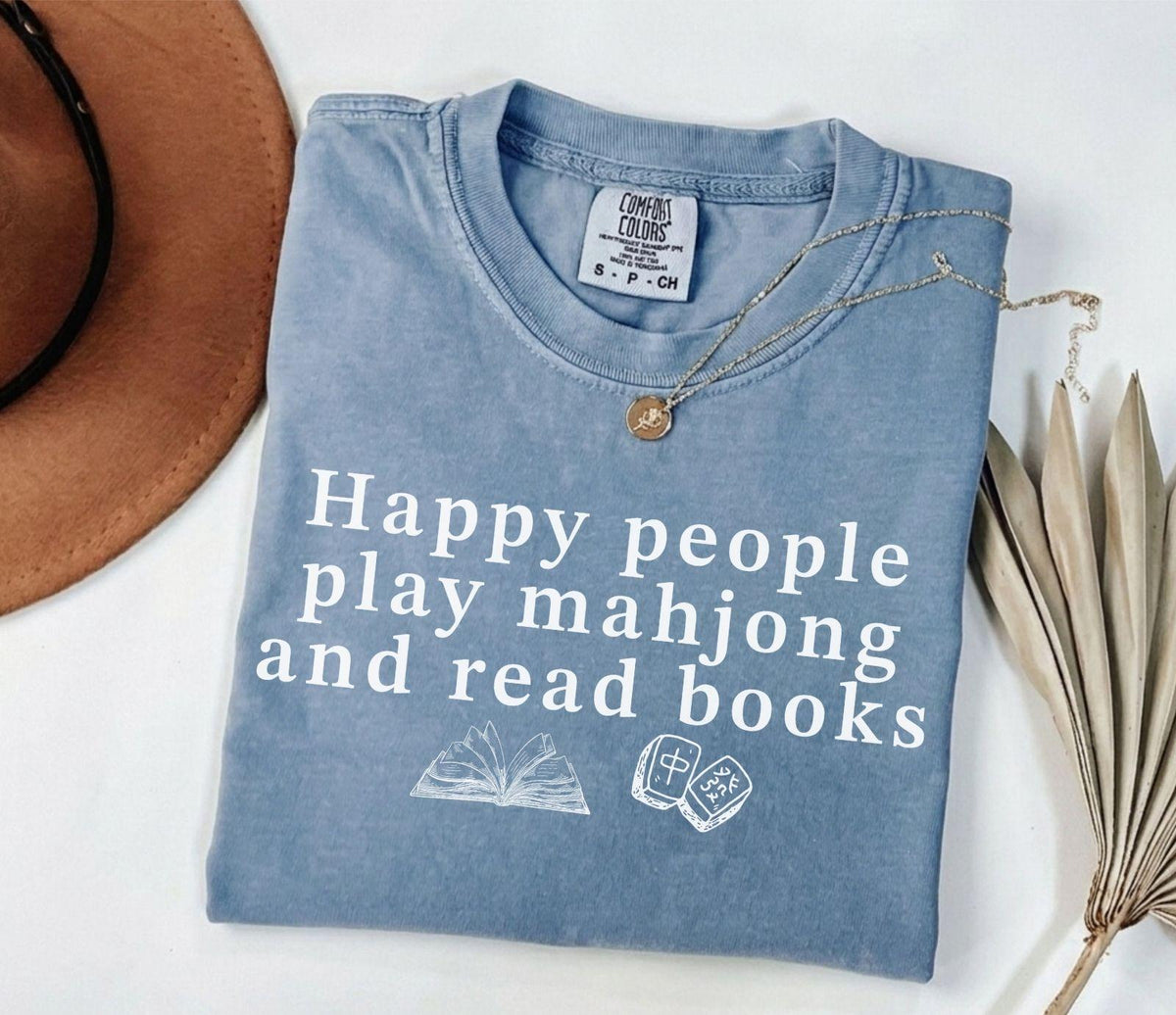 A comfort colors® shirt with the saying "Happy people play mahjong and read books"