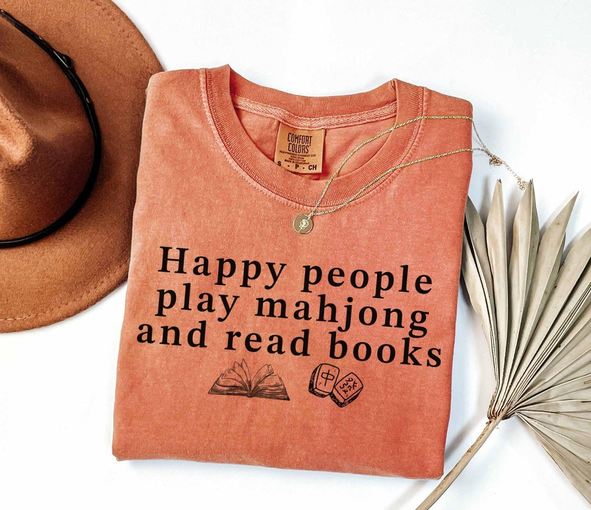 A comfort colors® shirt with the saying "Happy people play mahjong and read books"