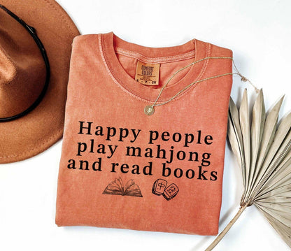 A comfort colors® shirt with the saying "Happy people play mahjong and read books"