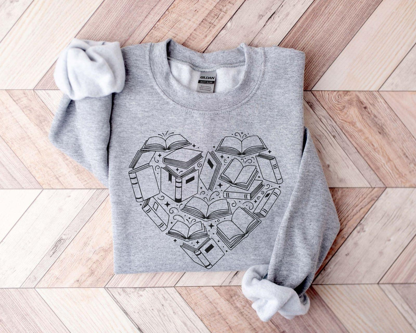 A Gildan 18000 sweatshirt with the saying "heart made of books"