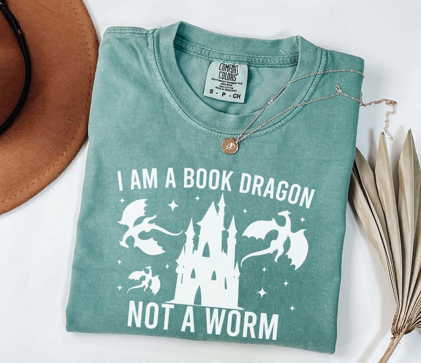 A comfort colors shirt with the saying "I am a book dragon not a work"