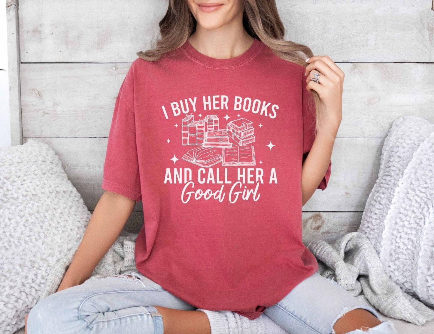A comfort colors shirt with the saying "I buy her books and call her a good girl"