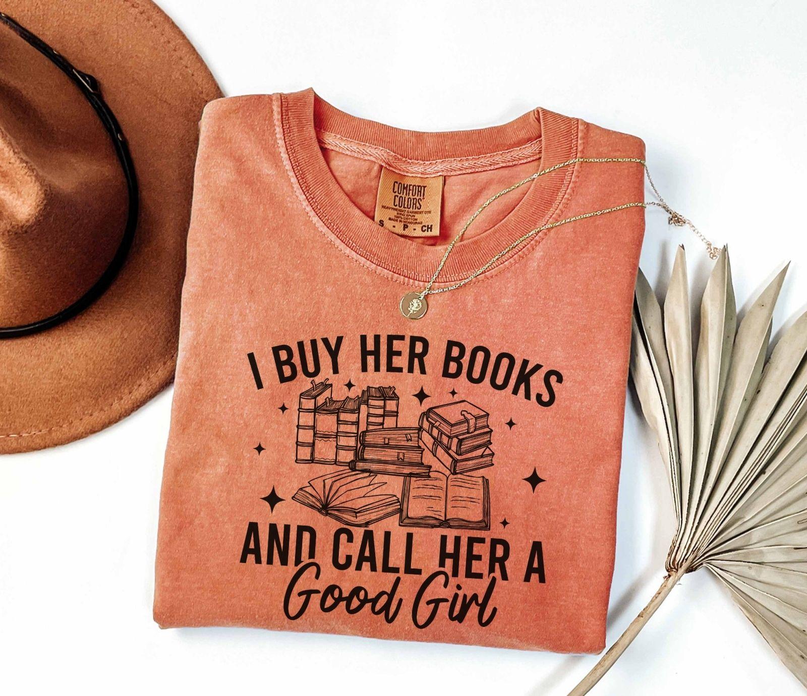 A comfort colors shirt with the saying "I buy her books and call her a good girl"