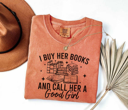 A comfort colors shirt with the saying "I buy her books and call her a good girl"