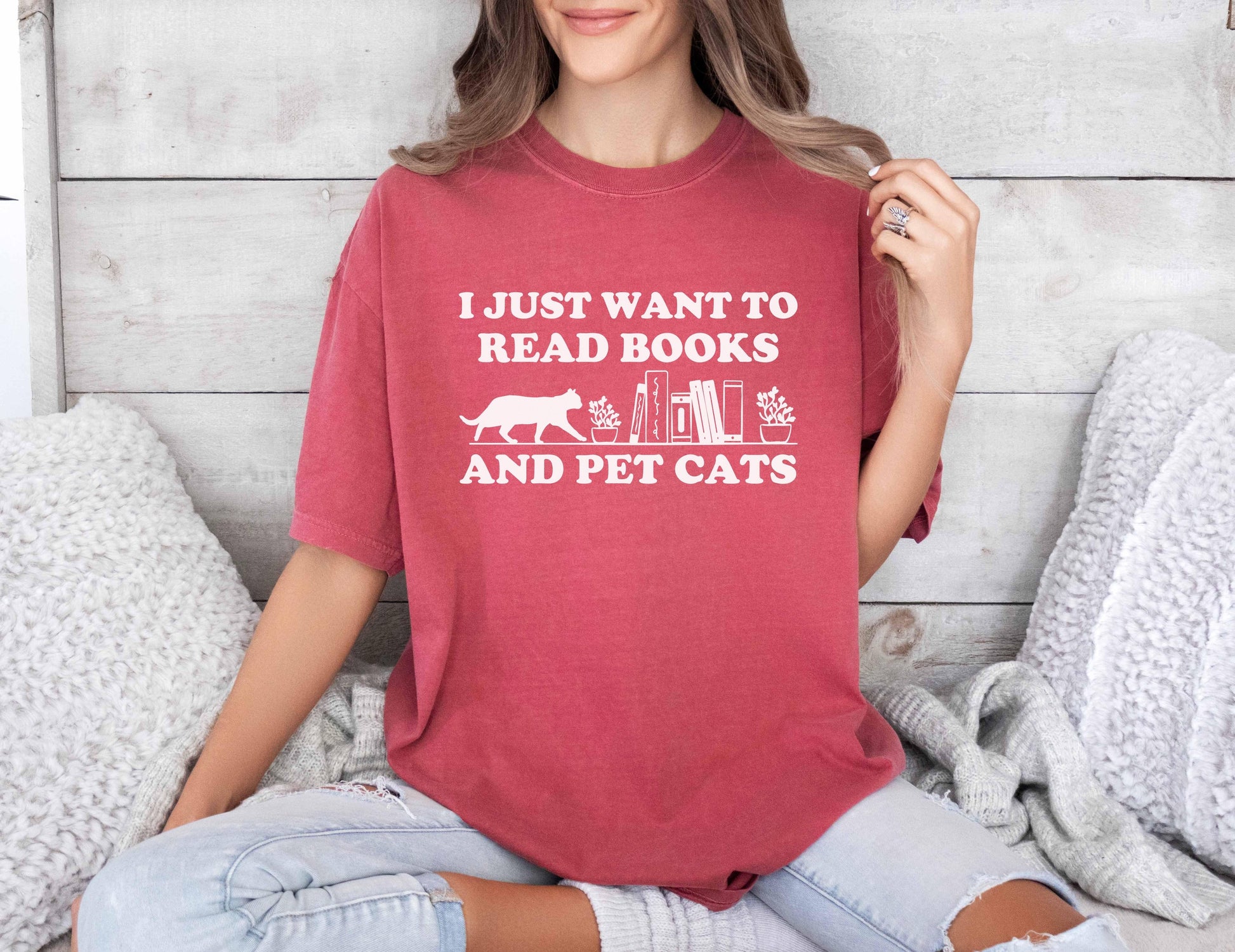 A comfort colors shirt with the saying "I just want to read books and pet cats"